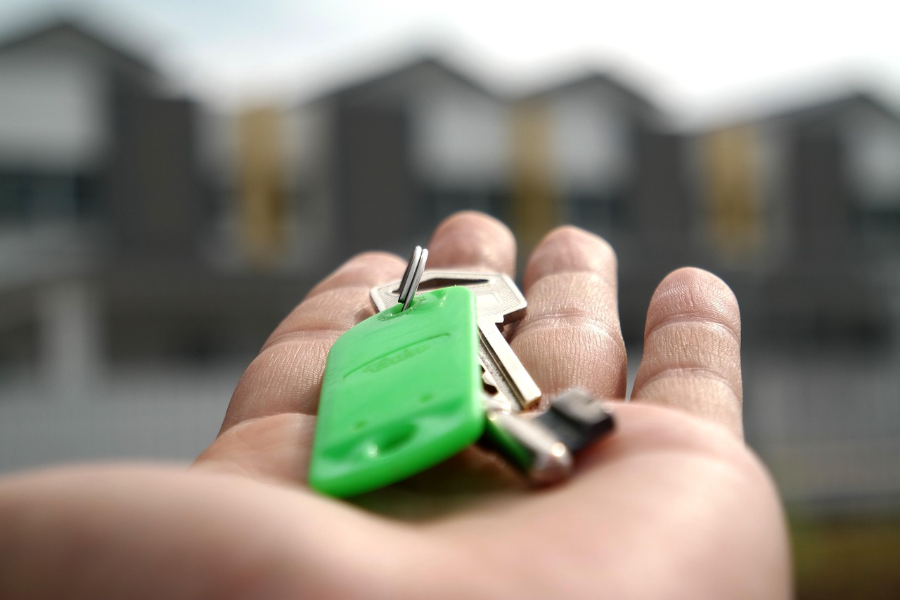 Hand holding house keys at closing